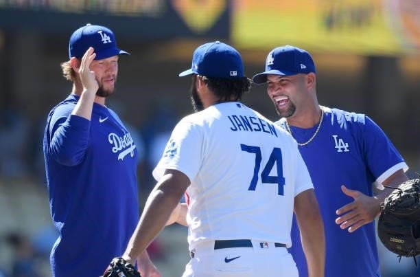 Relief pitcher Kenley Jansen of the Los Angeles Dodgers is congratulated by Albert Pujols and pitcher Clayton Kershaw after making his career 327th...