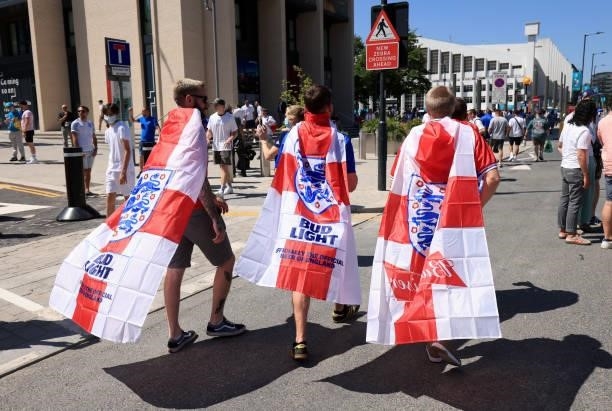 England fans draped in flags during the UEFA Euro 2020 Championship Group D match between England and Croatia on June 13, 2021 in London, United...