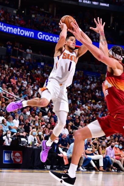 Devin Booker of the Phoenix Suns looks to pass the ball during Round 2, Game 4 of the 2021 NBA Playoffs on June 13, 2021 at the Ball Arena in Denver,...