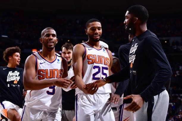Chris Paul and Mikal Bridges hi-five E'Twaun Moore of the Phoenix Suns during Round 2, Game 4 of the 2021 NBA Playoffs on June 13, 2021 at the Ball...