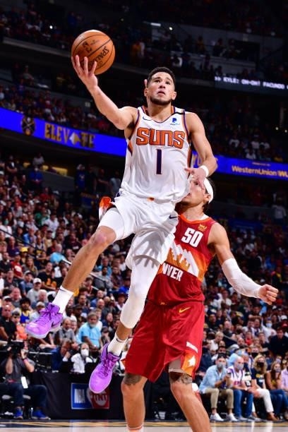 Devin Booker of the Phoenix Suns drives to the basket against the Denver Nuggets during Round 2, Game 4 of the 2021 NBA Playoffs on June 13, 2021 at...