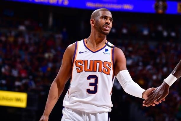 Chris Paul of the Phoenix Suns hi-fives teammates during Round 2, Game 4 of the 2021 NBA Playoffs on June 13, 2021 at the Ball Arena in Denver,...