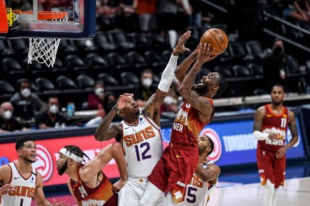 Will Barton of the Denver Nuggets shooter and scores around coverage by Torrey Craig of the Phoenix Suns in Game Four of the Western Conference...