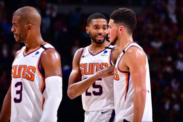 Mikal Bridges talks with Devin Booker of the Phoenix Suns during Round 2, Game 4 of the 2021 NBA Playoffs on June 13, 2021 at the Ball Arena in...