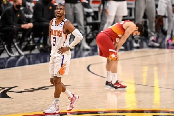 Chris Paul of the Phoenix Suns walks on the court as Facundo Campazzo of the Denver Nuggets pauses in the fourth quarter in Game Four of the Western...