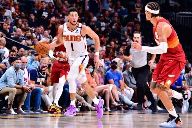 Devin Booker of the Phoenix Suns dribbles the ball during Round 2, Game 4 of the 2021 NBA Playoffs on June 13, 2021 at the Ball Arena in Denver,...