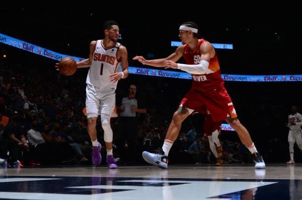 Aaron Gordon of the Denver Nuggets plays defense on Devin Booker of the Phoenix Suns during Round 2, Game 4 of the 2021 NBA Playoffs on June 13, 2021...