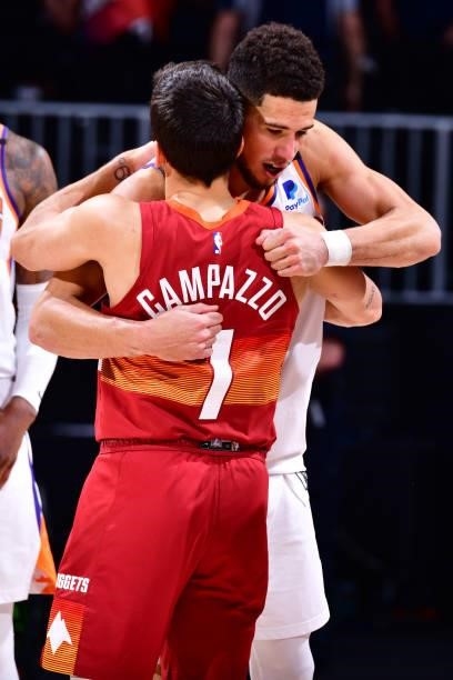 Devin Booker of the Phoenix Suns hugs Facundo Campazzo of the Denver Nuggets after the game during Round 2, Game 4 of the 2021 NBA Playoffs on June...