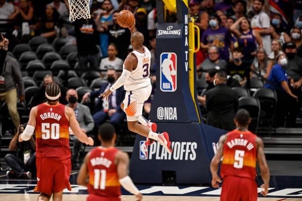 Chris Paul of the Phoenix Suns scores on a fast break layup against the Denver Nuggets in Game Four of the Western Conference second-round playoff...