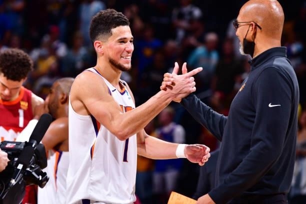 Head Coach Monty Williams of the Phoenix Suns hi-fives Devin Booker of the Phoenix Suns after the game against the Denver Nuggets during Round 2,...