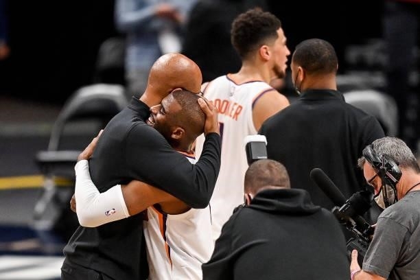Head coach Monte Williams of the Phoenix Suns hugs Chris Paul after action against the Denver Nuggets in Game Four of the Western Conference...