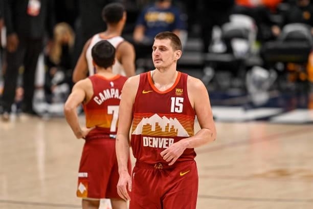 Nikola Jokic of the Denver Nuggets walks off the court after being ejected for a play involving Cameron Payne of the Phoenix Suns in Game Four of the...