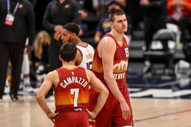 Nikola Jokic of the Denver Nuggets walks off the court after being ejected for a play involving Cameron Payne of the Phoenix Suns in Game Four of the...