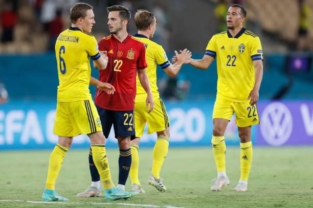 Sweden's defender Ludwig Augustinsson , Spain's midfielder Pablo Sarabia and Sweden's midfielder Robin Quaison react after the final whistle of the...
