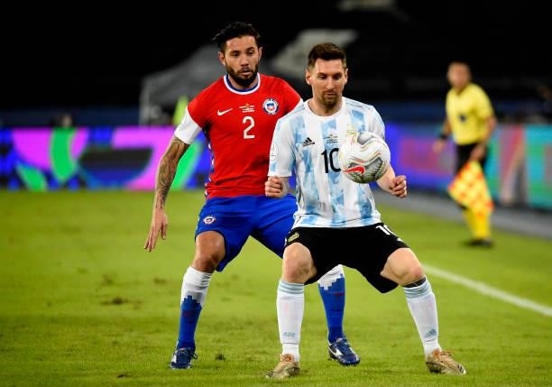 Lionel Messi of Argentina competes for the ball with Eugenio Mena of Chile ,during the match between Argentina and Chile as part of Conmebol Copa...