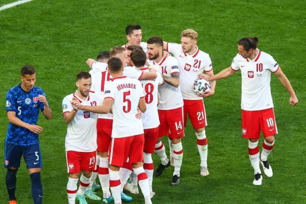 Karol Linetty of Poland celebrates with teammates after scoring their side's first goal during the UEFA EURO 2020 Group E football match between...