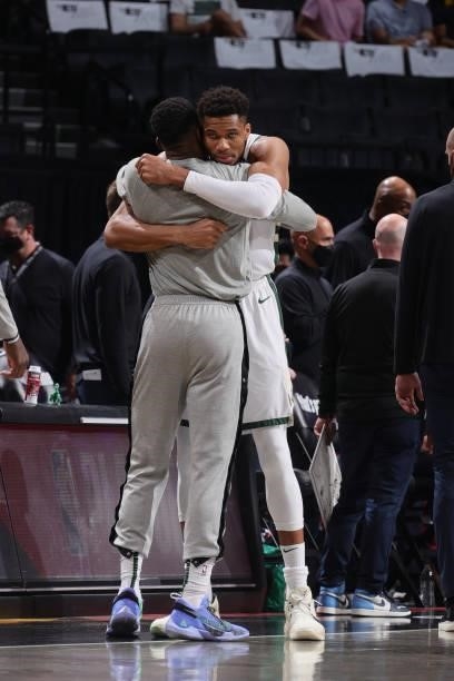 Giannis Antetokounmpo of the Milwaukee Bucks hugs Thanasis Antetokounmpo of the Milwaukee Bucks prior to the game against the Brooklyn Nets during...