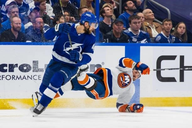 Jan Rutta of the Tampa Bay Lightning skates against a falling Casey Cizikas of the New York Islanders during the second period in Game Two of the...