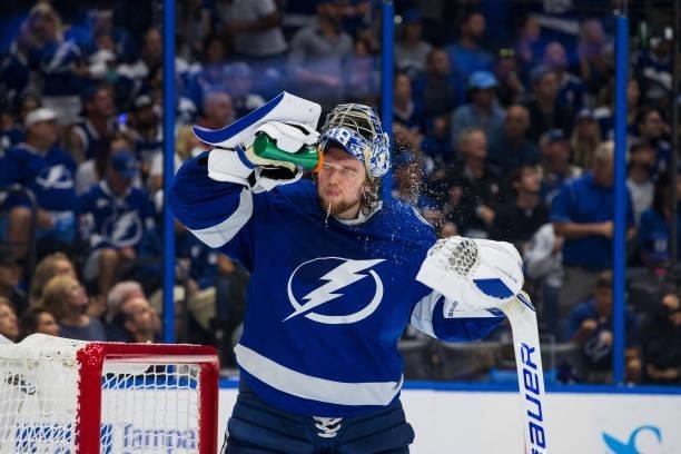 Goalie Andrei Vasilevskiy of the Tampa Bay Lightning sprays water on his face during a TV timeout against the New York Islanders during the second...
