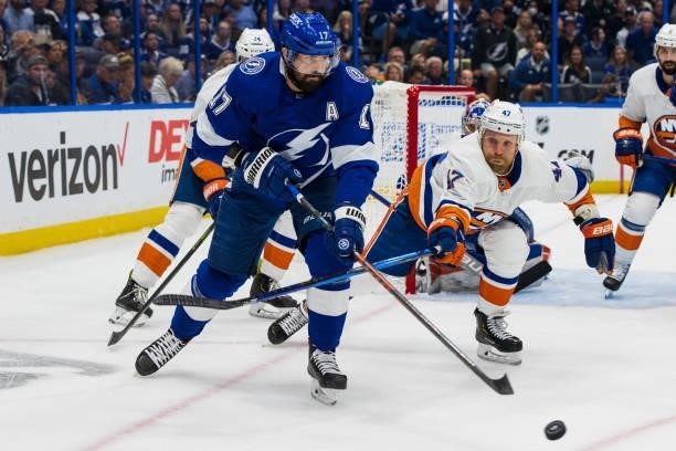Alex Killorn of the Tampa Bay Lightning skates against Leo Komarov of the New York Islanders during the first period in Game Two of the Stanley Cup...