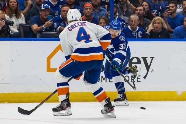 Yanni Gourde of the Tampa Bay Lightning skates against Andy Greene of the New York Islanders during the first period in Game Two of the Stanley Cup...