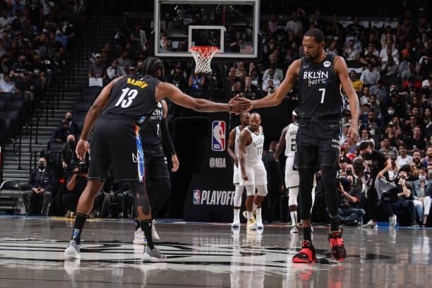 James Harden of the Brooklyn Nets high fives Kevin Durant of the Brooklyn Nets during Round 2, Game 5 of the 2021 NBA Playoffs on June 15, 2021 at...