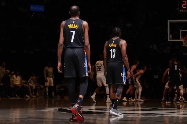 Kevin Durant of the Brooklyn Nets and James Harden of the Brooklyn Nets look on during Round 2, Game 5 of the 2021 NBA Playoffs on June 15, 2021 at...