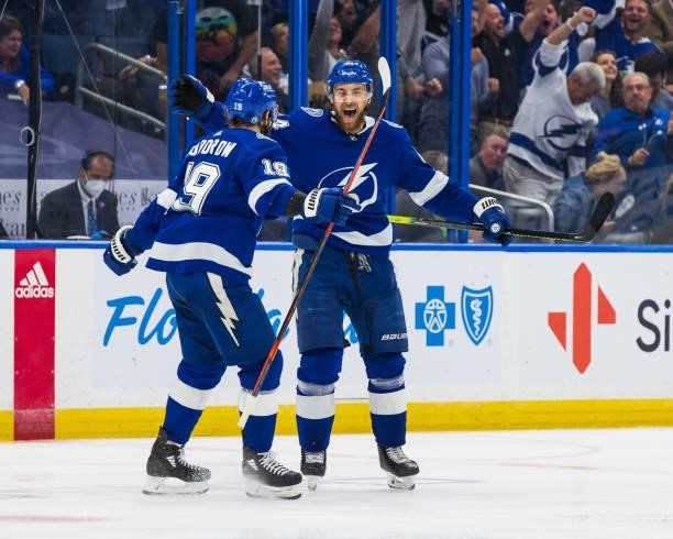 Jan Rutta of the Tampa Bay Lightning celebrates his goal with teammate Barclay Goodrow against the New York Islanders during the third period in Game...