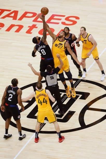 Marcus Morris Sr. #8 of the LA Clippers and Rudy Gobert of the Utah Jazz jump for the ball during the opening tip-off during Round 2, Game 4 of 2021...