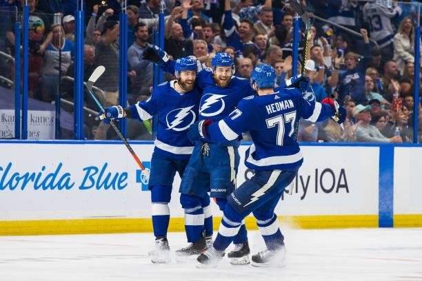 Jan Rutta of the Tampa Bay Lightning celebrates his goal with teammates Barclay Goodrow and Victor Hedman against the New York Islanders during the...