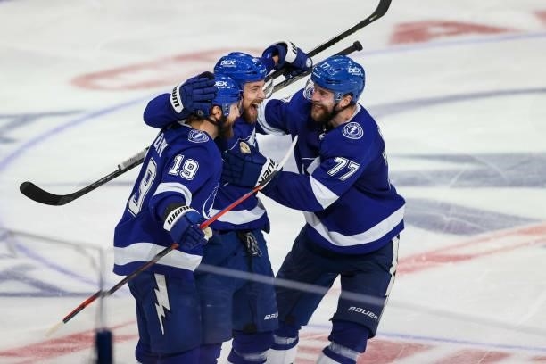 Jan Rutta of the Tampa Bay Lightning celebrates a goal with teammates Victor Hedman and Barclay Goodrow against the New York Islanders during the...