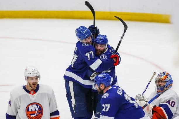 Victor Hedman of the Tampa Bay Lightning celebrates a goal with teammate Brayden Point against the New York Islanders during the third period in Game...