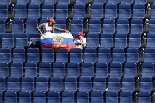 Russia fans pose with their flag prior to the UEFA EURO 2020 Group B football match between Finland and Russia at the Saint Petersburg Stadium in...