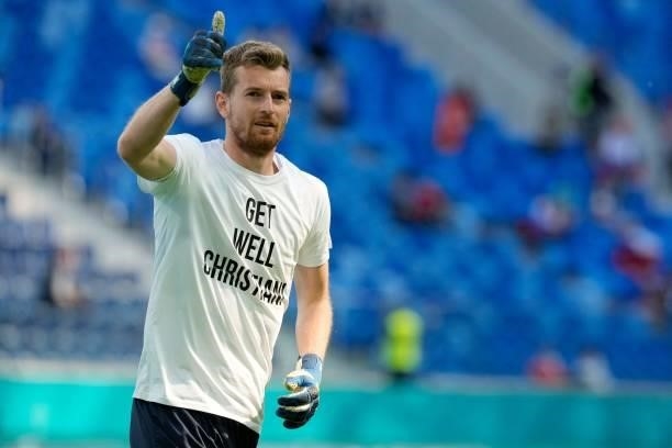 Finland's goalkeeper Lukas Hradecky wear a shit with a greeting to Denmark's Christian Eriksen prior to the UEFA EURO 2020 Group B football match...