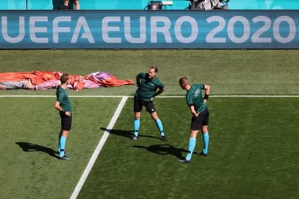 Dutch referee Danny Makkelie and his assistants warm up prior the UEFA EURO 2020 Group B football match between Finland and Russia at the Saint...