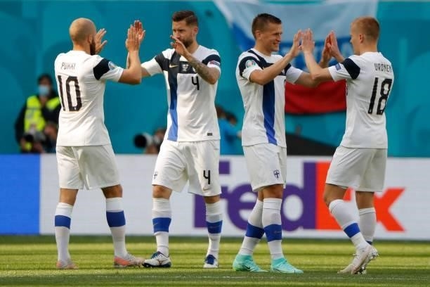 Finland's players give each other high fives prior to the UEFA EURO 2020 Group B football match between Finland and Russia at the Saint Petersburg...