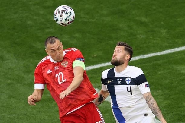 Russia's forward Artem Dzyuba and Finland's defender Joona Toivio vie for the ball during the UEFA EURO 2020 Group B football match between Finland...