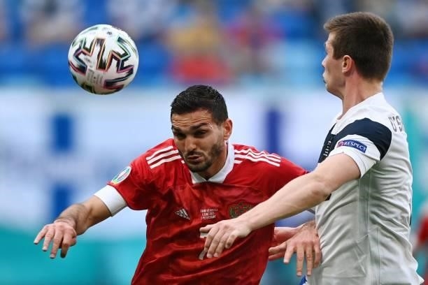 Russia's midfielder Magomed Ozdoev and Finland's defender Daniel O'Shaughnessy vie during the UEFA EURO 2020 Group B football match between Finland...
