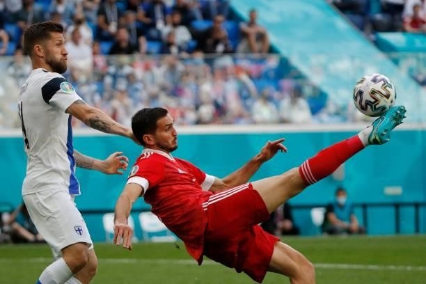 Finland's defender Paulus Arajuuri and Russia's midfielder Magomed Ozdoev vie during the UEFA EURO 2020 Group B football match between Finland and...