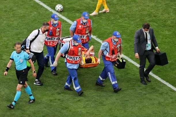 Russia's defender Mario Fernandes is stretchered off injured during the UEFA EURO 2020 Group B football match between Finland and Russia at the Saint...
