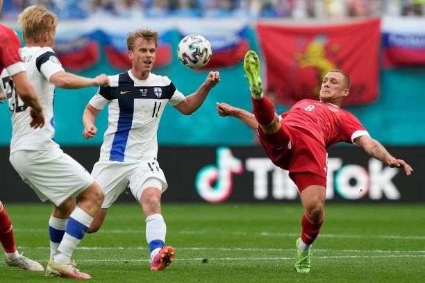 Finland's midfielder Rasmus Schuller and Russia's midfielder Dmitriy Barinov vie during the UEFA EURO 2020 Group B football match between Finland and...