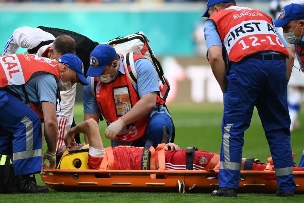 Russia's defender Mario Fernandes is stretchered off injured during the UEFA EURO 2020 Group B football match between Finland and Russia at the Saint...