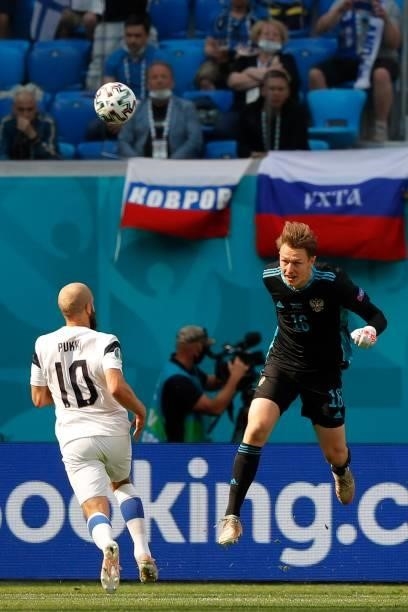 Russia's goalkeeper Matvei Safonov heads the ball away from Finland's forward Teemu Pukki during the UEFA EURO 2020 Group B football match between...