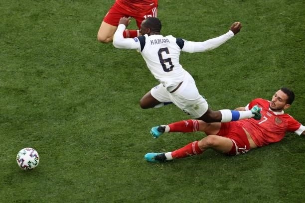 Finland's midfielder Glen Kamara is tackled by Russia's midfielder Magomed Ozdoev during the UEFA EURO 2020 Group B football match between Finland...