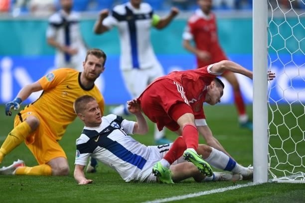 Finland's defender Jere Uronen and Russia's defender Vyacheslav Karavaev collide with the post during the UEFA EURO 2020 Group B football match...