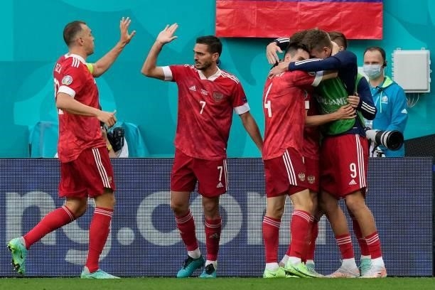 Russia's forward Aleksey Miranchuk celebrates scoring the opening goal with his teammates during the UEFA EURO 2020 Group B football match between...