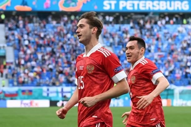 Russia's forward Aleksey Miranchuk celebrates scoring the opening goal with his teammates during the UEFA EURO 2020 Group B football match between...