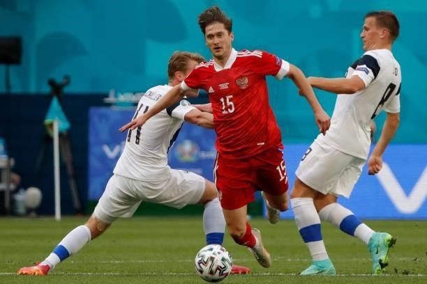 Russia's forward Aleksey Miranchuk is challangd by Finland's midfielder Rasmus Schuller and Finland's midfielder Robin Lod during the UEFA EURO 2020...