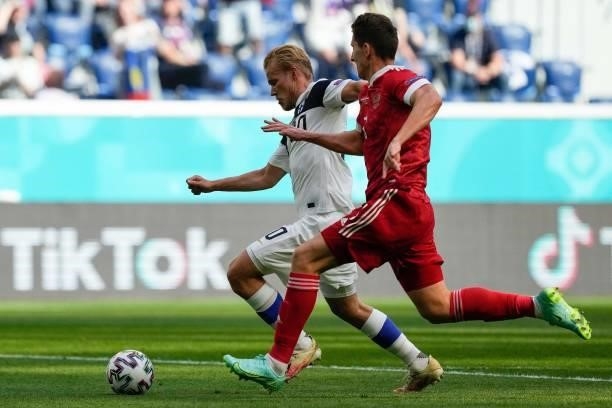 Finland's forward Joel Pohjanpalo is chassed by Finland's defender Daniel O'Shaughnessy during the UEFA EURO 2020 Group B football match between...