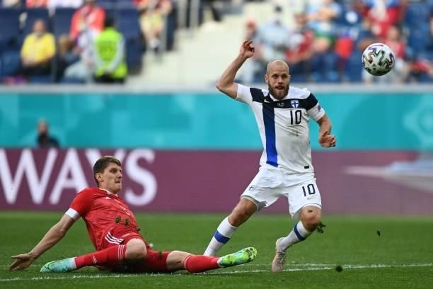 Russia's defender Igor Diveev and Finland's forward Teemu Pukki vie during the UEFA EURO 2020 Group B football match between Finland and Russia at...